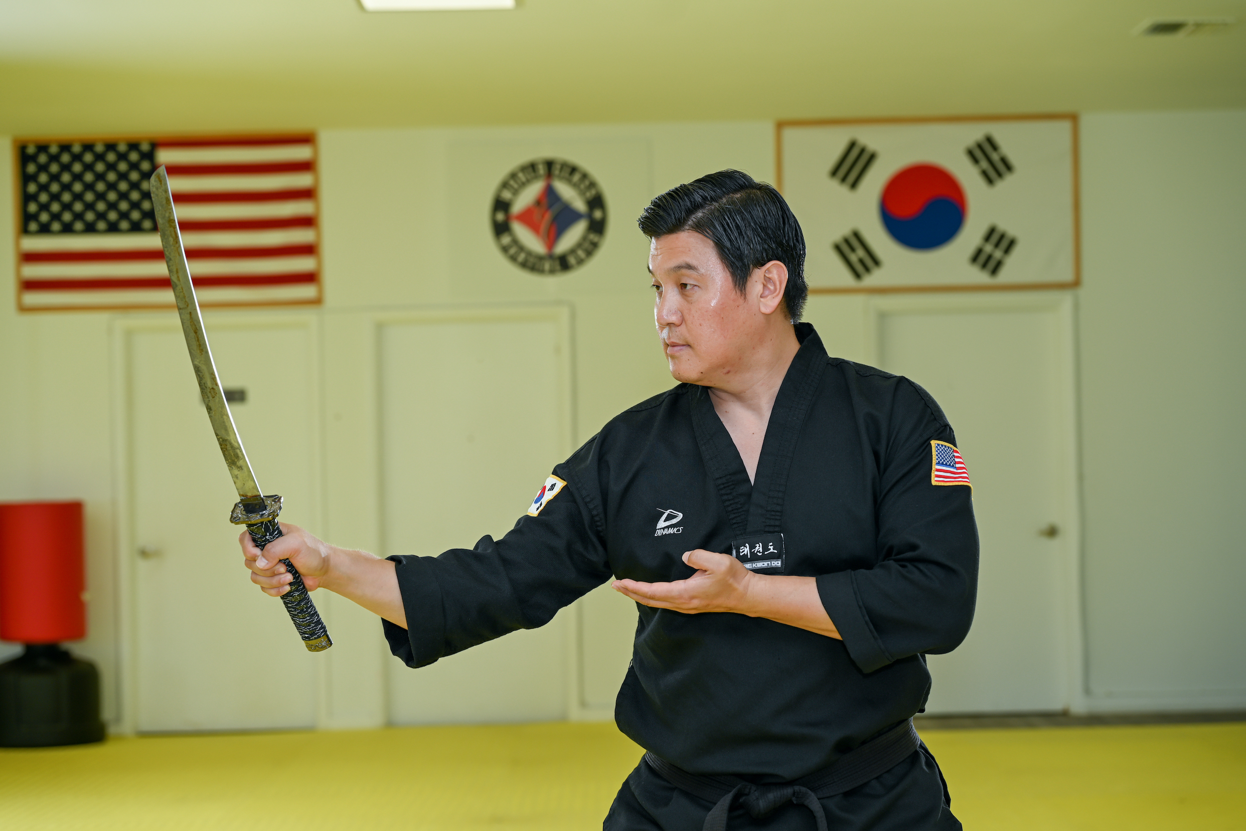 Master Jeong holds a small sword in his hand.