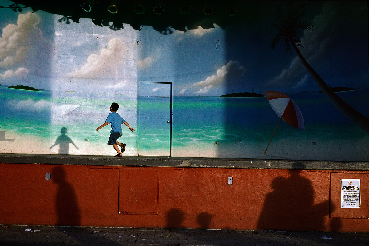 kid running in front of beach mural