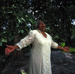 Olympia Alfaro (apuón - ceremonial lead singer) at her home, Miami. Photograph by Carl Juste.