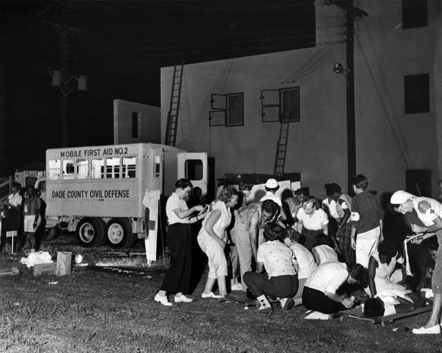 A group of African American and white citizens take part in a nighttime Dade County Civil Defense first aid drill. January 14, 1960. Miami News Collection, HistoryMiami. 1995-277-5212.