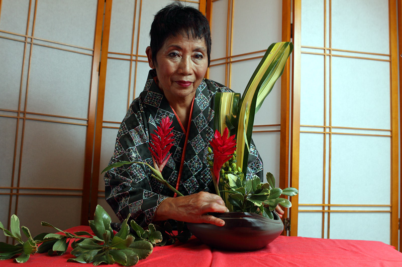 Mieko Kubota arranges an ikebana flower arrangement