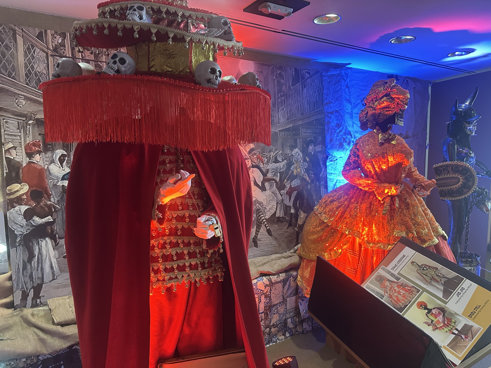 three carnival costumes in a gallery