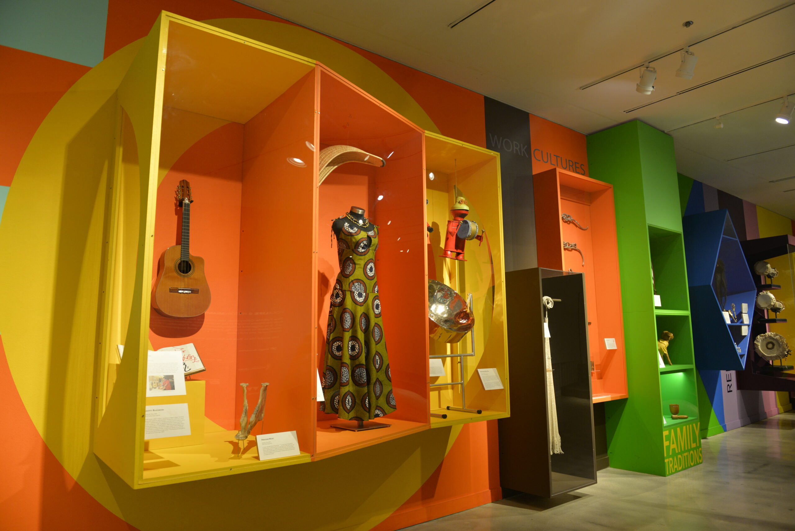Folklife Gallery featuring artifacts in colorful cases.