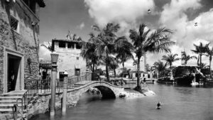 black and white image of the venetian pool, a vast outdoor Mediterranean style pool with stone steps and an archway
