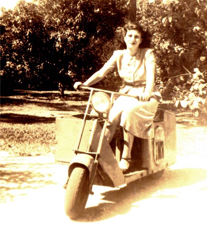 Photo of a young woman, Leonore Hoffner, sitting on a motor scooter in 1948.