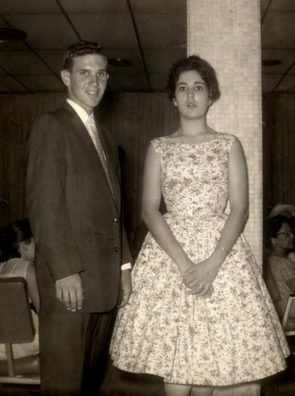 Black and white photo of a young woman, Marilu Espinosa, and her brother standing together.