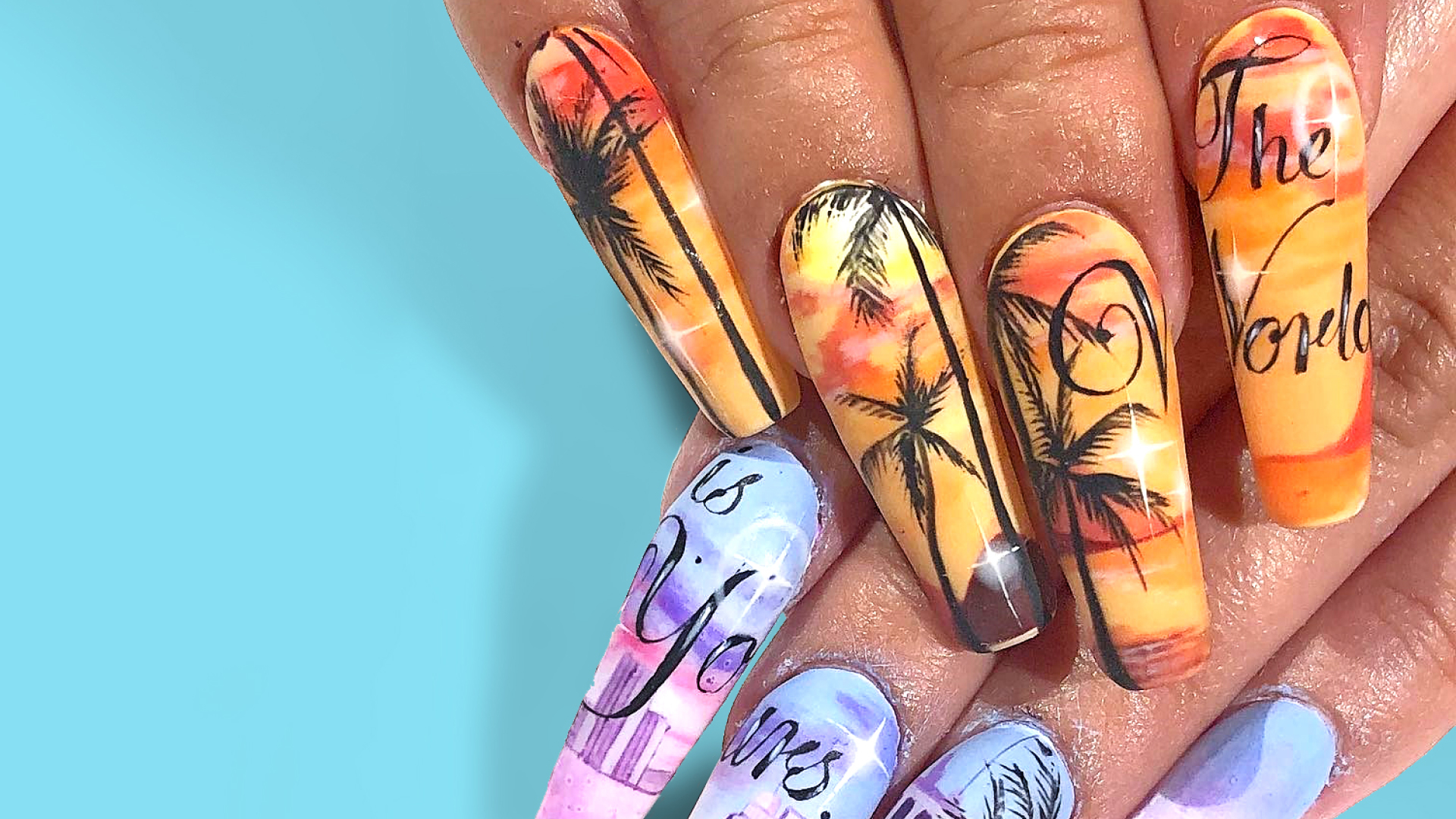 A close up of Miami inspired nail art. The wearer has brown skin and long sets of nails on their hands. One hand has dark palm trees against a yellow and orange sky; and the other hand has a pink and blue motif with the Miami skyline.