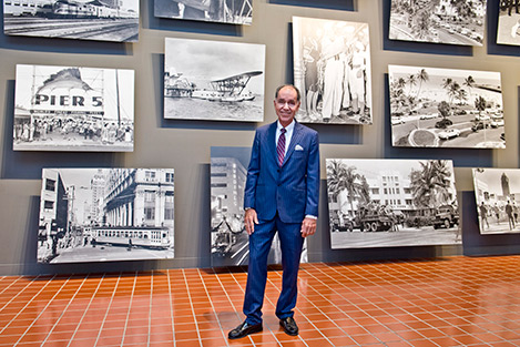 Dr. George standing in front of a wall with pictures