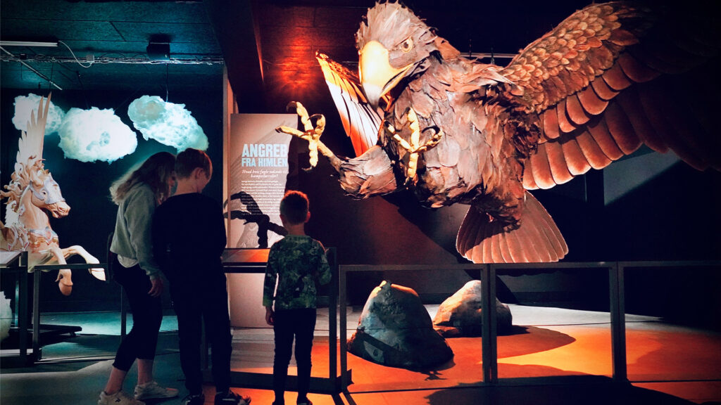 Children looking at giant eagle in museum gallery