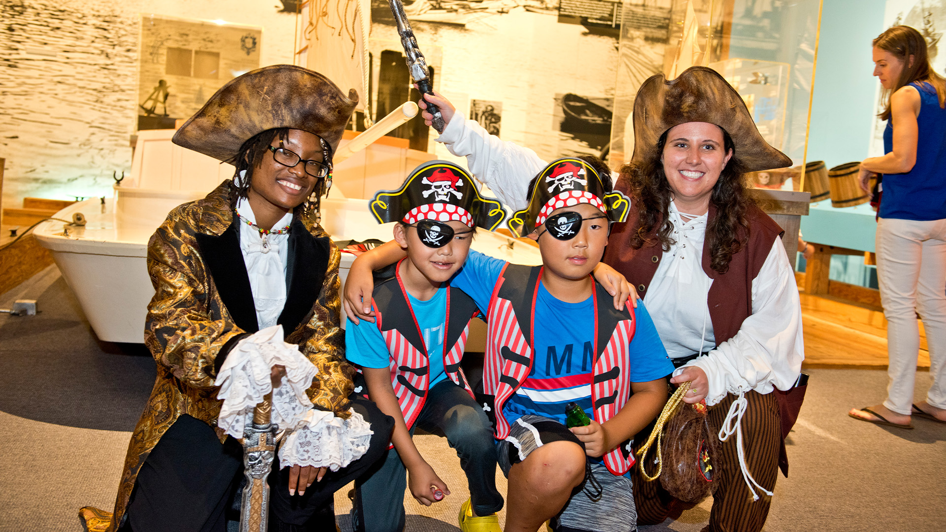 Two female pirates with children at the museum.