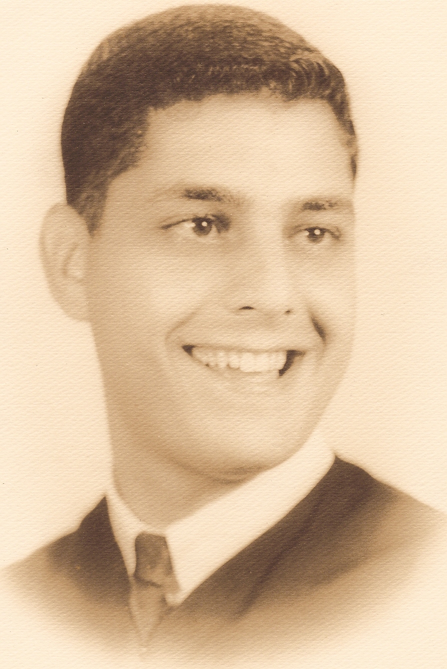 Headshot of a young man, Ray Skop, who smiles and looks off camera. Taken in 1962.