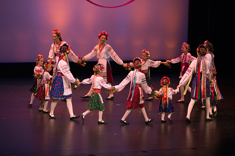 women and girl dancers performing as they hold hands in a circle
