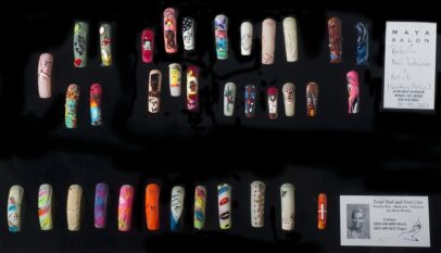 A museum display of single nail designs with a label