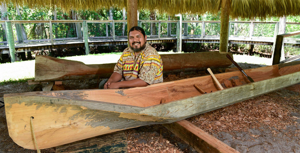 man sitting in canoe