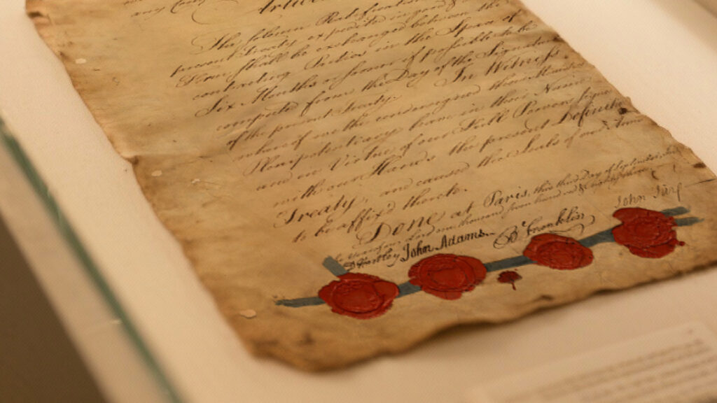 Zoomed-in view of a founding era document; an aged yellowed document with script writing