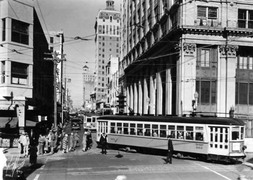 Historic black and white image of a street interception with a trolley of old Miami 
